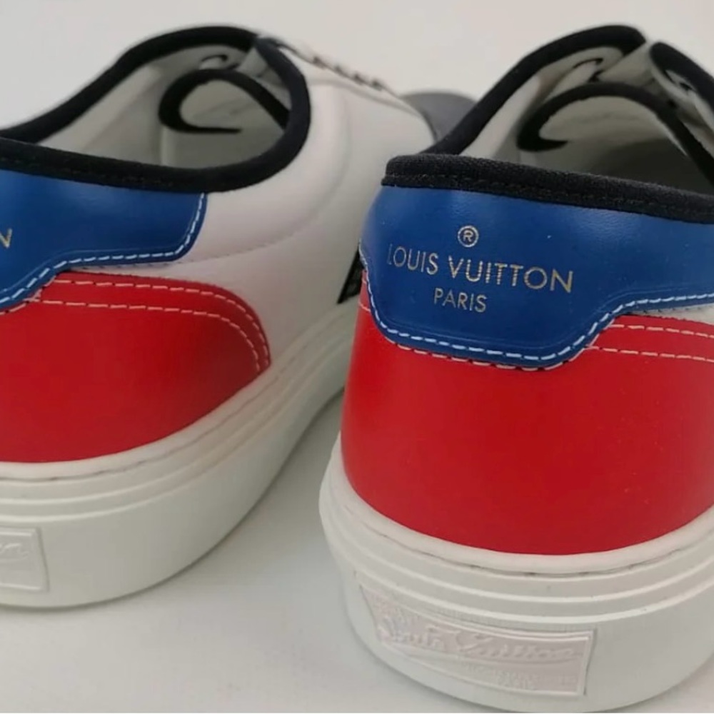 Louis Vuitton leather sneakers with red, blue, and white pattern.